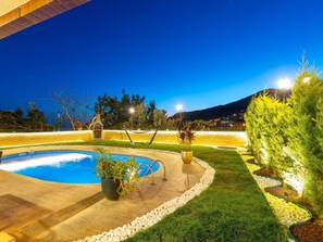 A swimming pool with a surrounding deck, a hammock, and potted plants. - Alanya Luxury Villas (Alanya)