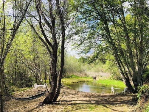 Cozy Wild West Covered Wagon next to River