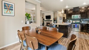 A modern kitchen with dark cabinets, a microwave, and a stove. - Hart Haus at Stevens Pass- spacious w/ hot tub, EV charger, close to hikes! (Skykomish)