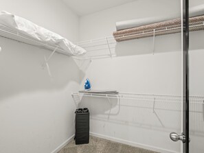 A room with a bunk bed, a small ironing board, and a trash bin. - Clovis House, Sleeps 10, Hammock, Covered Patio, Game Table (Clovis)