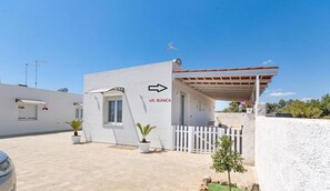 Stylish residence with an entrance, paved driveway, and garden area.