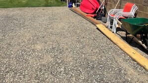A gravel driveway leading to a house with a covered patio area. - RV space on the River Unit B -minutes from Gorge concerts (Quincy)