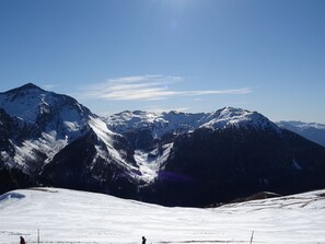 A snow-covered mountain range with clear skies.