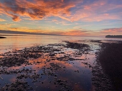 Walk out the front door, across a grass lawn and onto a sandy beach