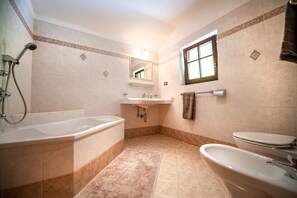 A bathroom with a bathtub, sink, and toilet.