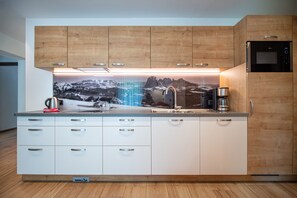Fridge, microwave, coffee/tea maker, cookware/dishes/utensils