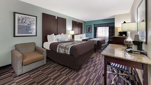 A hotel room with a large bed, a desk, a chair, and a small sofa. - Baymont by Wyndham Elizabeth City (Elizabeth City)