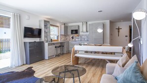 Ein modernes Apartment mit Küche, Essbereich und Wohnzimmer.