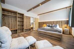 Ein Schlafzimmer mit einem hölzernen Bett, einem Einbauschrank und einem großen Spiegel.