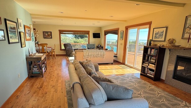 A spacious living room with a sofa, a coffee table, and a fireplace.
