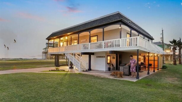 A two-story house with a balcony and a covered outdoor area. - Beach/Bay, Boat/Fish, Sand/Surf, Deck/Vistas (Freeport)
