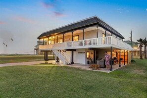 A two-story house with a balcony and a covered outdoor area. - Beach/Bay, Boat/Fish, Sand/Surf, Deck/Vistas (Freeport)