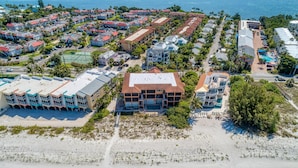 An aerial view of a coastal resort with multiple buildings, a beach, and a pool area. - Bradenton Beach Club Bliss-2 Bedroom-2 Bathroom Condo-2 Pools-hottub-private Beach Access (Bradenton Beach)