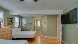 A bedroom with two beds, a dresser, and a television. - Casa Rover - Pet Friendly w/ Fenced-in Yard, Family Friendly, Mins to Downtown Nashville (Nashville)