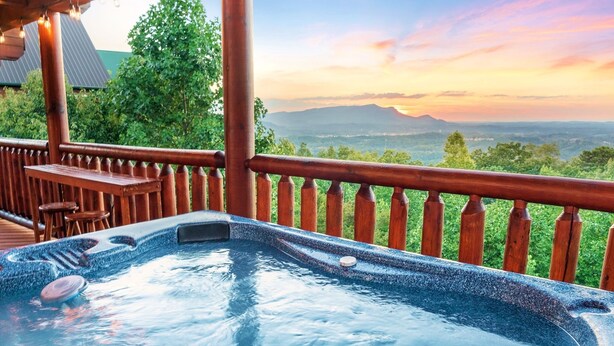 A hot tub on a wooden deck with a view of mountains and trees. - E.Z drive! WOW VIEWS, hotTUB 🎱 POOL TABLE, fireplace Close to Gatbg & Dollywood (Sevierville)