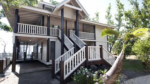 A two-story building with a balcony and a staircase.