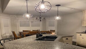 A kitchen with a granite countertop, a sink, and pendant lighting. - Cheerful, spacious, sunny & comfy 4-bdrm home (Rock Springs)