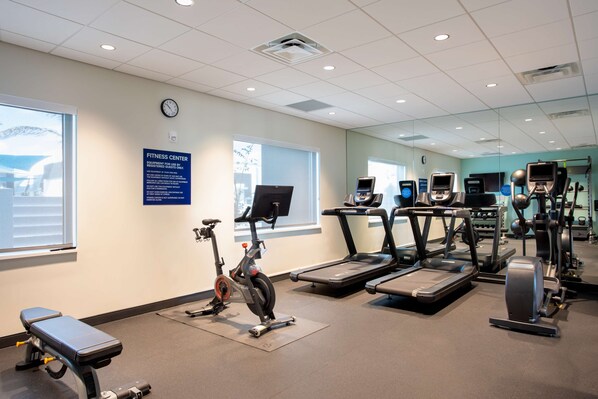 A fitness center with treadmills, an elliptical, and a stationary bike.
