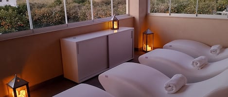 A spa area with massage chairs, a cabinet, and lanterns.