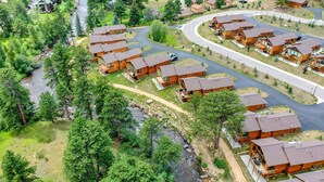 A cluster of wooden cabins with a river running through the property. - River Front/.5 mi to EP/ AC/fishing (Estes Park)
