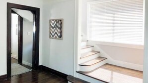 A staircase with wooden steps and a white wall. - Gorgeous, Fully Remodeled Open Floor-Plan! (Pontiac)
