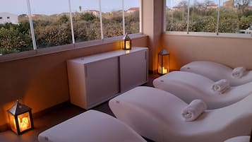 A spa area with massage chairs, a cabinet, and lanterns.