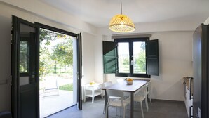 A modern kitchen with a dining area, a sofa, and a view of the outdoors. - Spa Suite Villa dell'Eden C unit 2 with 5 beds, Cir 19082044C217077 (Gorgo Lungo)