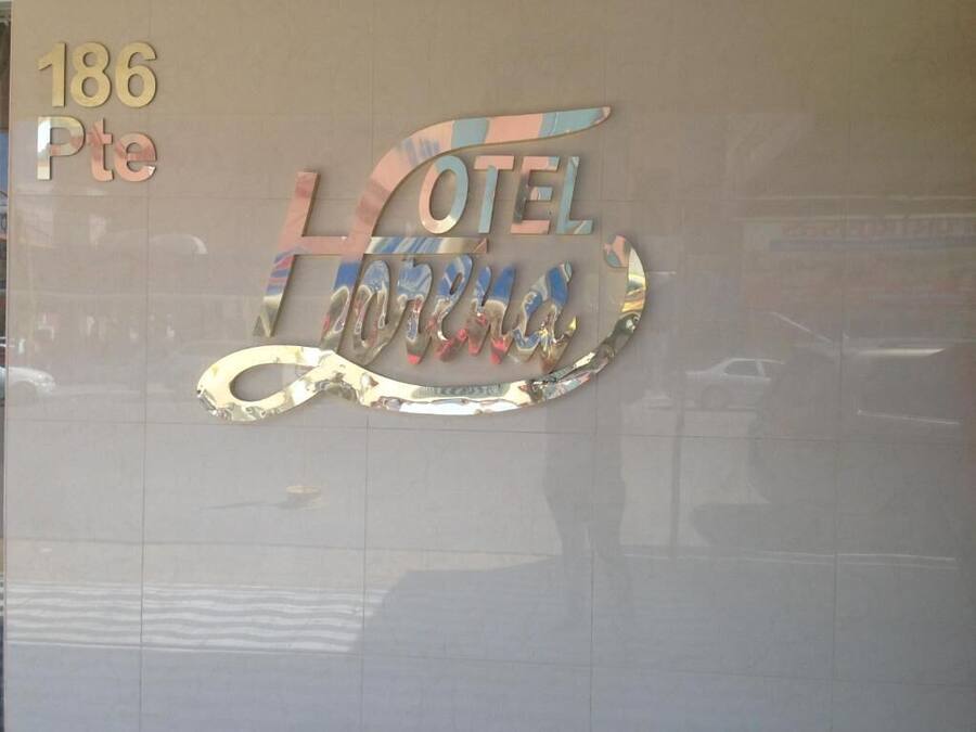 Een hotelschild met de naam 'HOTEL FERRARA' en het adres '186 Pte'.