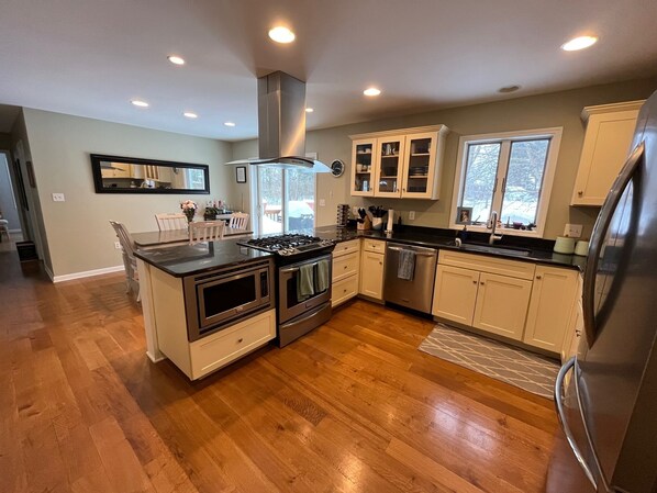 Enjoy cooking in this well-equipped kitchen with a gas stove, oven, and stainless steel appliances.