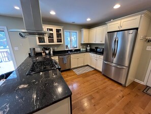 Enjoy cooking in this well-equipped kitchen with an oven, gas range, and large window.
