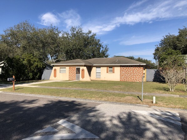 A single-story house with a gabled roof, a front porch, and a small front yard. - 3/2 Modern Valrico Entire Home. Pet-Friendly! (Valrico)