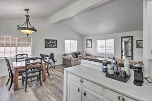A spacious living area with a dining table, chairs, a sofa, and a coffee station. - 5 Mi to the River! Bullhead City Home w/ Pool (Bullhead City)