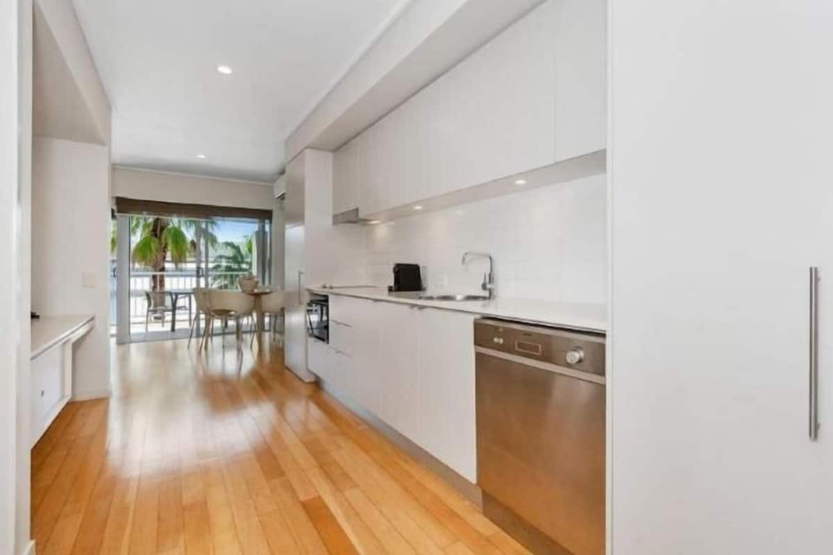 Fridge, electric kettle, cleaning supplies, dining tables