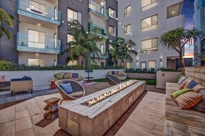 Relax by the fire pit in our outdoor lounge, surrounded by comfortable seating and stunning views.