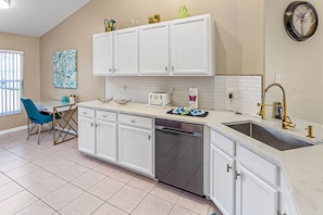 Enjoy cooking in this well-equipped kitchen with a dishwasher, sink, and toaster.