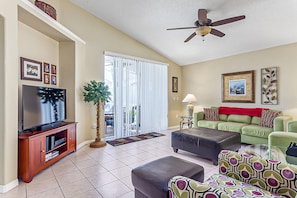 Relax in this stylish living room with a flat-screen TV, comfortable sofa, and beautiful artwork.