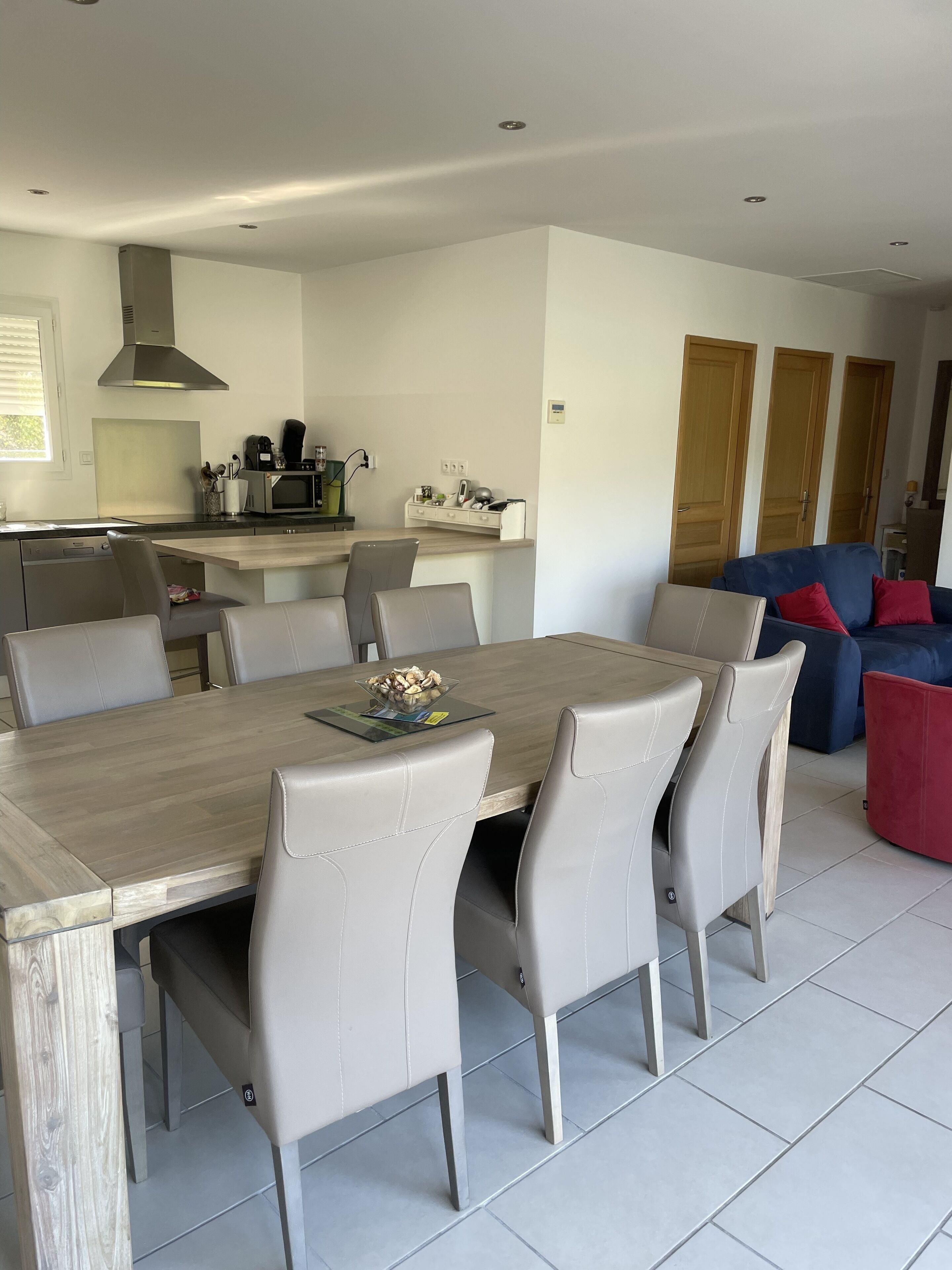 A modern kitchen with a dining area.