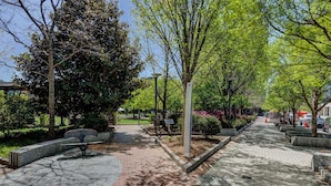 A paved pathway lined with trees and benches, leading to a building labeled 'Center City'.
