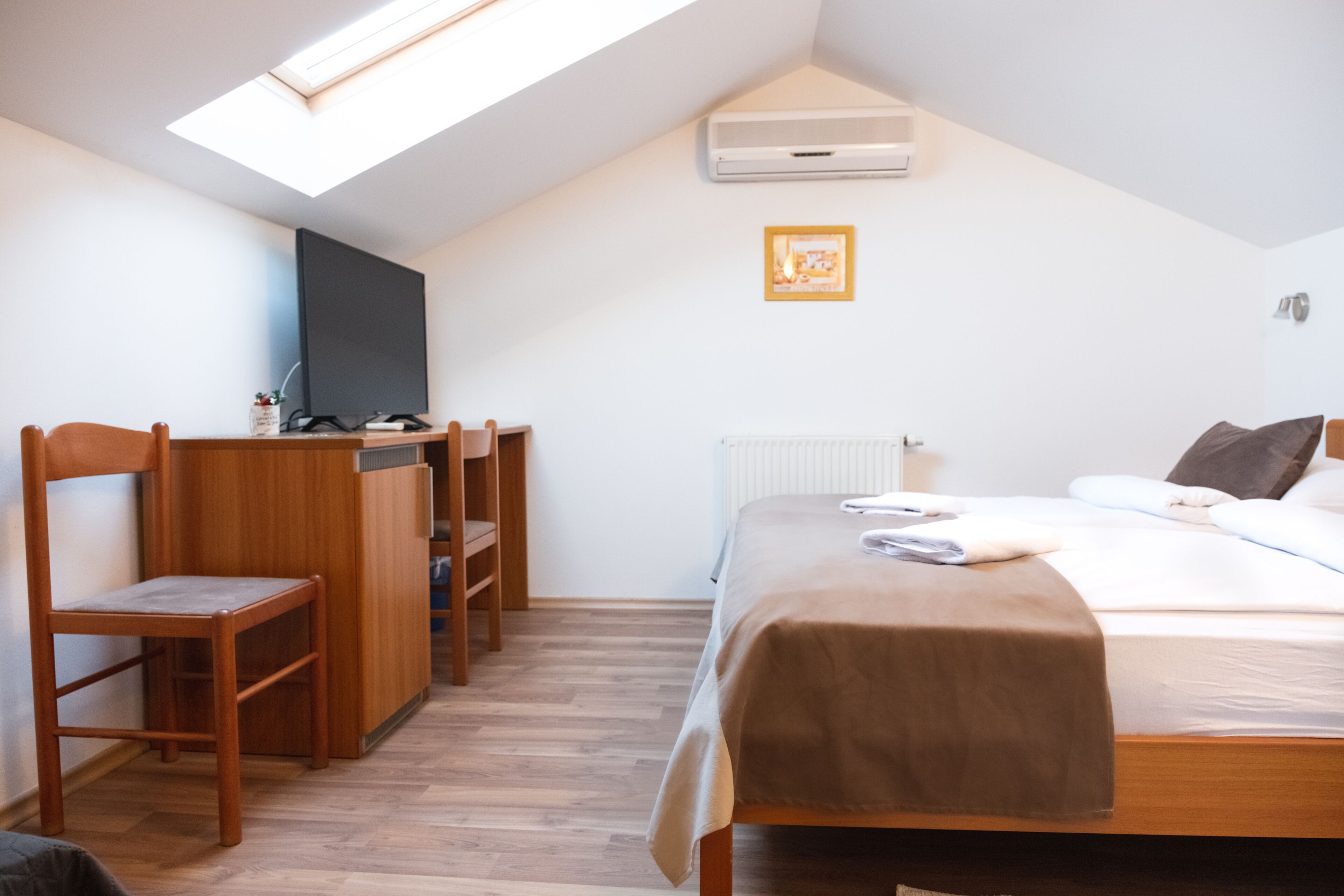 Ein Schlafzimmer mit einem Bett, einem Schreibtisch und einem Stuhl.