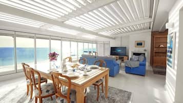 Luxe suite, uitzicht op zee | Woonkamer | Een 32-inch smart-tv met kabelzenders, een televisie en Netflix