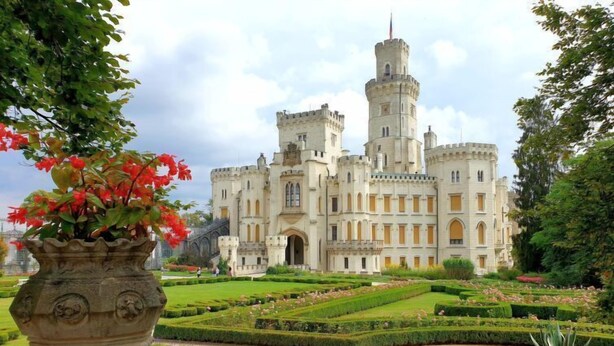 A large castle-like building with a central tower, surrounded by manicured gardens and a pathway leading to the entrance. - Vlhlavy u Hluboké by Interhome (Hluboka nad Vltavou)