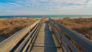 A wooden boardwalk leading to the beach with grassy dunes on either side. - Modern Tropical Bungalow, 3BR 2 Bath (Murrells Inlet)