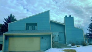 A single-story house with a garage, a chimney, and a snow-covered yard. - Unique Home Near Temple and Parks, great for families! (Pocatello)