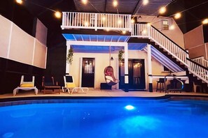 A two-story building with a pool, outdoor seating, and a staircase. - ⛱  Spacious, Private Pool, Golf Cart - just RELAX  🏝 (Panama City Beach)