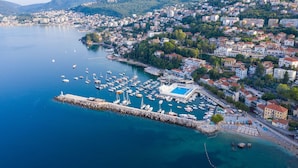 An aerial view of a coastal town with a marina, buildings, and mountains in the background. - Pool Villa Panorama Mojdez /w Sea View (Mojdez)
