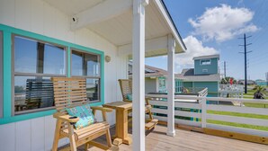 A wooden deck with outdoor seating, including a bench and a table. - Gulf Coast Views! Coastal Winter Gem in Galveston (Galveston)