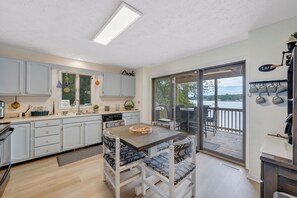 Enjoy meals in the kitchen with an oven, sink, and range hood, and dine al fresco on the outdoor deck with a seating area.