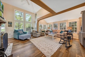 Relax in this inviting living room with a plush area rug, comfortable seating, and a large coffee table.