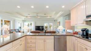 A spacious kitchen with a central island, built-in appliances, and a dishwasher.
