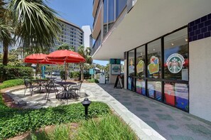 Relax in style with outdoor seating and shade under red umbrellas.